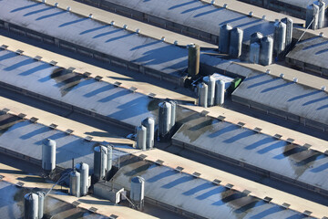 Aerial view of a frost covered chicken farm in the UK. An aerial photograph showing a large chicken farm in the UK. It was taken from a helicopter on a cold frosty day with low winter shadows.