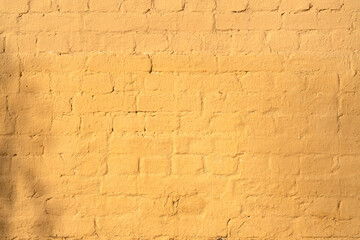 Old rough yellow brick wall texture. Background