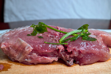 Slice of raw bonito with a few branches of parsley. It is a fish from the Cantabrian Sea
