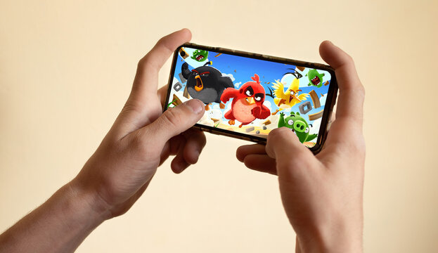 Los Angeles, California, USA - 4 May 2021 Hands holding a smartphone with Angry Birds game on display screen, Illustrative Editorial