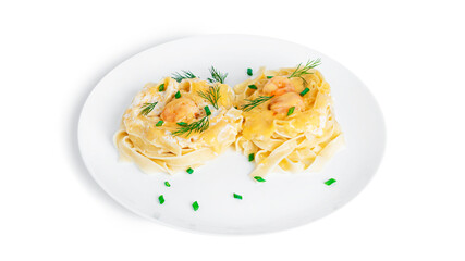 Fettuccine pasta with shrimp in cream sauce on white plate isolated on a white background. Nests of pasta with seafood and cheese.