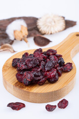 dried cherry, without bones, on a wooden board, on a white background