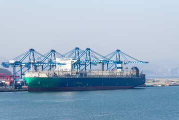 Cargo, container ship, powered by Liquefied Natural Gas (LNG), berthed in port of Busan. 