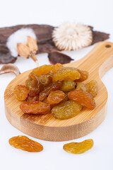 white large raisins, without bones, on a wooden board, on a white background
