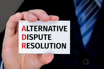 Text adr on bussiness card being held by a business man.