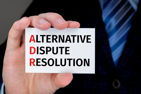Text adr on bussiness card being held by a business man.