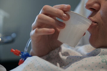 young woman in the hospital taking her pills