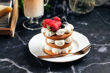 Gingerbread cake on a plate next to a cup of coffee
