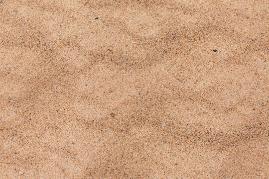 Sea shore yellow sand in close up.
