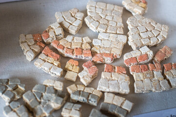 Broken remains of excavated Mosaic floor pieces from a Roman Villa in West Sussex, England