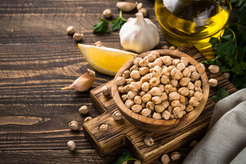 Chickpeas in white bowl at light kitchen table.