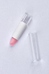 Top view of pink lipstick isolated on white background.
