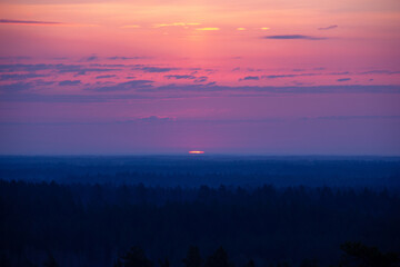 Beautiful sunrise above a top of trees