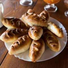 Apple pies on a plate are served with tea and jam.