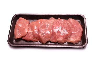 Turkey fillet in a black plastic container isolated.