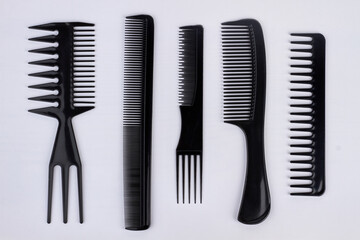 Collection of plastic combs for hair isolated on white background.