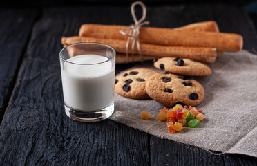 International Milk Day photo. Clay cup with milk, candied fruit and cookies on a wooden table 