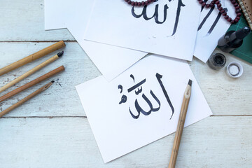 Arabic handwriting with ink on paper, Arabic letters mean the name of Muslim god 