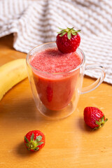 Strawberry and banana smoothie in glass glasses
