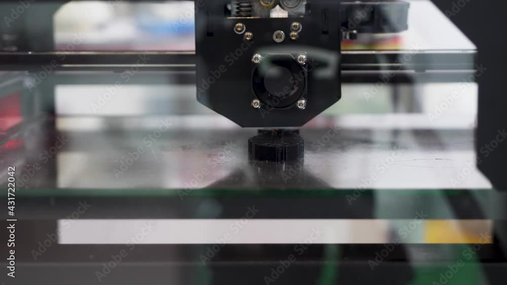 Poster automatic device 3d printer prints the form of molten plastic. hdr. close up of modeling a black pla