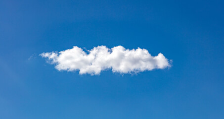 Cloud, one single white on clear blue sky, sunny spring day.