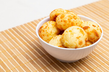 Cheese bread on the wooden table, with white towel.