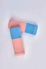 Close up of two colorful erasers isolated on white background.