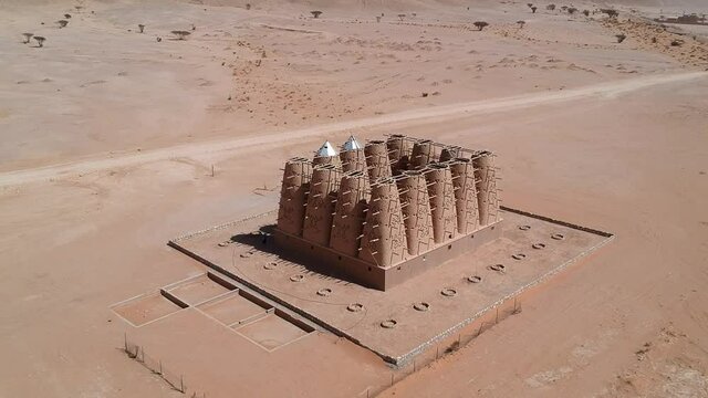 Camera drone flies over the abandoned traditional mud brick Arab dovecote in the Riyadh Province, Saudi Arabia