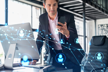 Businessman in suit using smart phone to check new candidates for international business...