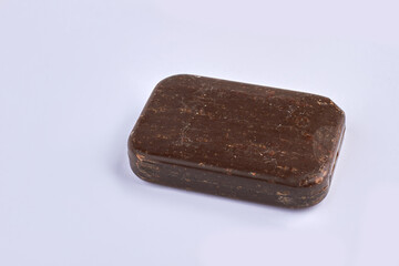 Brown natural homemade soap bar on gray background.
