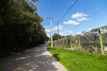 Fototapeta premium Asphalt road with houses next to it and solar energy plates.