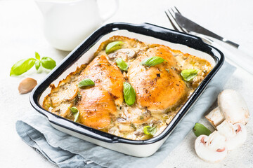 Baked chicken breast with mushrooms in cream sauce.