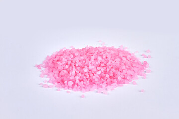 Pile of pink bath salt isolated on white background.