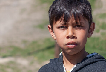 Portrait of young gypsy boy in Roma settlement 