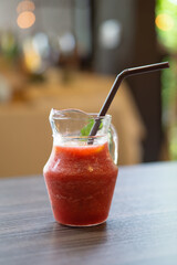 glass of stawberry juice in jar.