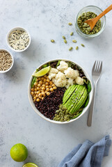 Bowl with avocado, black rice, chickpeas, cabbage, spinach and salad. Healthy eating. Vegetarian food.