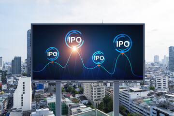 IPO icon hologram on road billboard over day time panorama city view of Bangkok. The hub of initial...