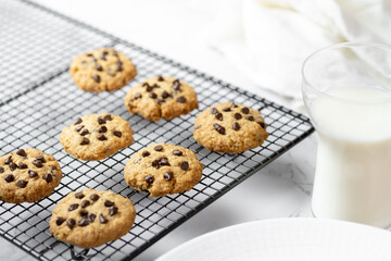 Delicious Whole Wheat Chocolate Chip Cookies set on white cafe table.