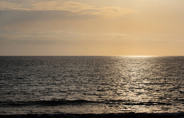 Background and scenic image with horizon of the sun setting on the sea