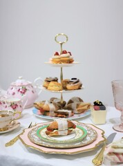 Table set up for tea party, focus on sandwich on the vintage plate