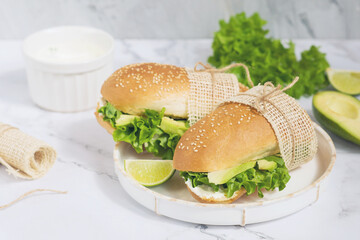 Sandwiches with avocado and herbs on a white plate