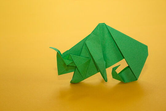 origami chameleon on a yellow background