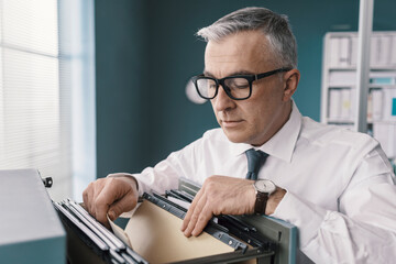 Businessman searching for files and documents