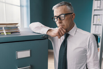 Pensive businessman thinking in the office