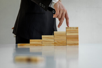 Businesswoman protect wooden block fall to planning and strategy in risk to business Alternative and prevent. Investment Insurance ,Business risk control concept,