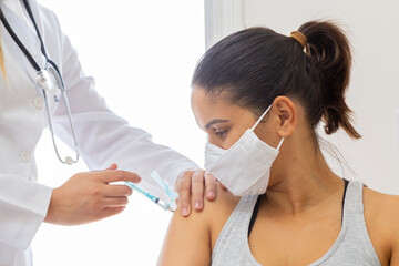 Female doctor holding mask on patient's shoulder. Close up - obrazy, fototapety, plakaty