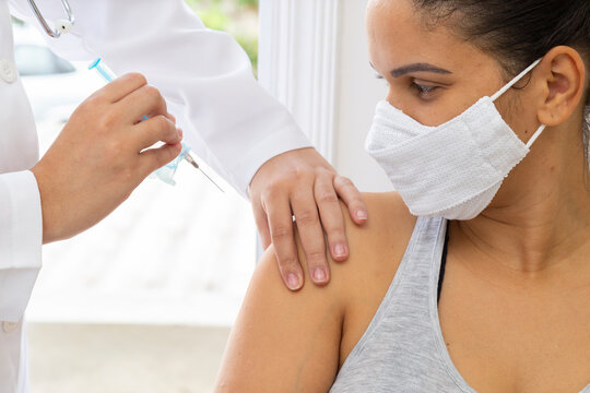 Medical mask patient looking applying injection. Close up.