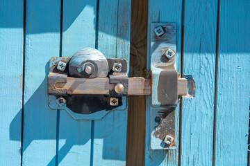 Close up of metal lock on blue door 