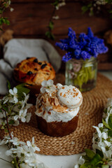 Easter cake decorated with white petals, nuts and macaroon. easter cupcake and blossoming apple tree branches