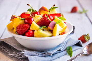 Naklejka na ściany i meble Fresh fruit salad with strawberries and cherries
